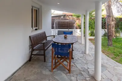 a table and chairs sitting on a patio at Katerlove Beach House in Faliraki