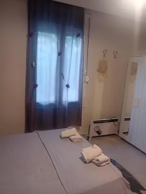 a bedroom with a bed with two towels on it at IRINIS HOUSES in Rhodes Town