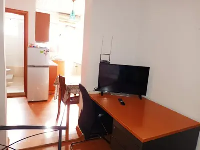 an office with a desk with a television on it at IRINIS HOUSES in Rhodes Town