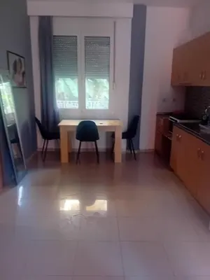 a kitchen with a table and chairs and a window at IRINIS HOUSES in Rhodes Town