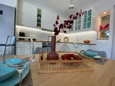 a table with a vase and a basket with flowers at Filoxenia Apartment in Asgourou