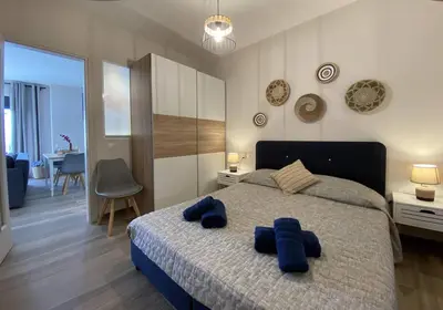 a bedroom with a bed with blue towels on it at Filoxenia Apartment in Asgourou