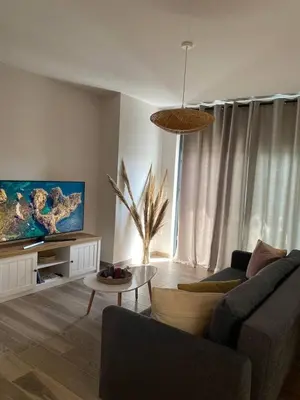 a living room with a couch and a table at Filoxenia Apartment in Asgourou