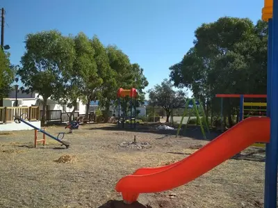 a playground with a red slide in a park at Stella Luxury Apartment Kalathos in Kalathos