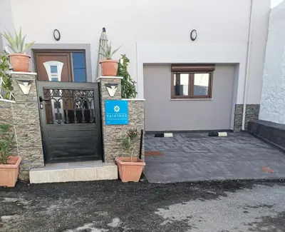 a front door of a house with potted plants at Stella Luxury Apartment Kalathos in Kalathos