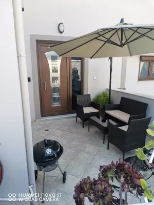 a patio with a table and an umbrella at Stella Luxury Apartment Kalathos in Kalathos