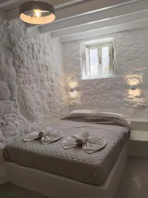 a bedroom with a bed with two towels on it at Oniropagida Nisyros apartment #1 in Nikiá