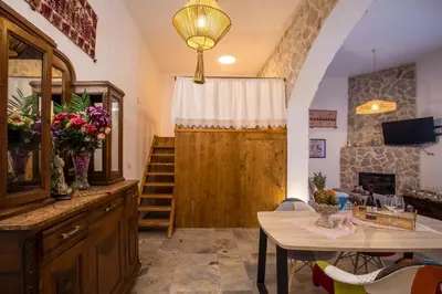 a living room with a wooden door and a table at Traditional Loft Casa Di Vini in Kalithies