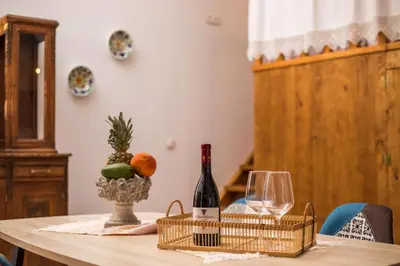 a table with a bottle of wine and a glass at Traditional Loft Casa Di Vini in Kalithies