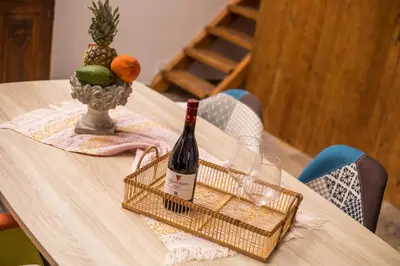 a bottle of wine in a basket on a table at Traditional Loft Casa Di Vini in Kalithies