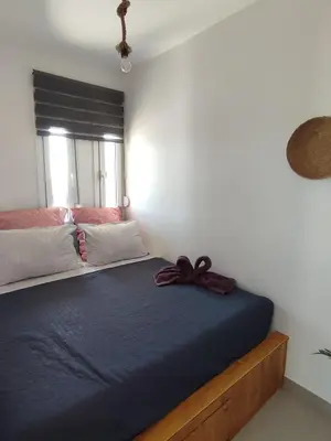 a bedroom with a bed with a bow on it at Kalokairini Avra in Archangelos