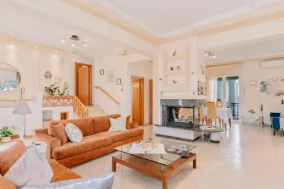 a living room with a couch and a fireplace at Propodes Luxury Villa in Pastida