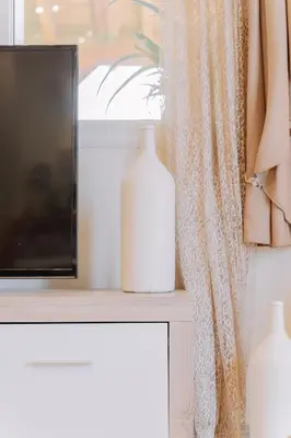 a window with a television and a vase on a table at Propodes Luxury Villa in Pastida