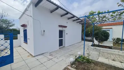 a white house with a blue fence around it at Blue and White in Kremasti