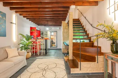 a living room with stairs leading to a kitchen at Mandorla Apartments in Rhodes Town
