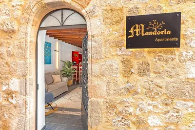 a sign for a restaurant on the side of a building at Mandorla Apartments in Rhodes Town
