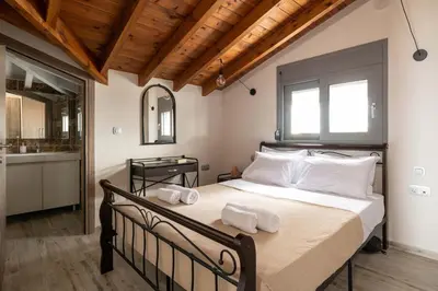 a bedroom with a large bed with towels on it at Tsatos Luxury Residence in Kremasti