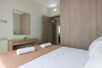 a bedroom with a bed with two towels on it at Tsatos Luxury Residence in Kremasti