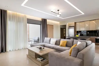 a living room with a couch and a table at Tsatos Luxury Residence in Kremasti