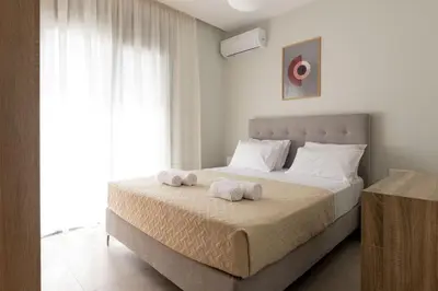 a bedroom with a large bed with towels on it at Tsatos Luxury Residence in Kremasti