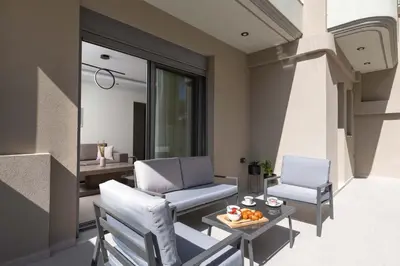 two chairs and a table in a living room at Tsatos Luxury Residence in Kremasti