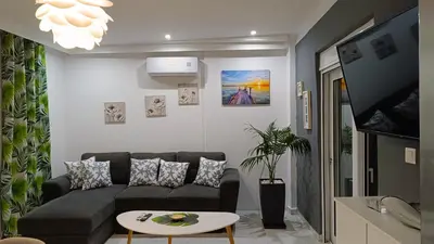 a living room with a couch and a tv at Villa Eunomia in Gennadi