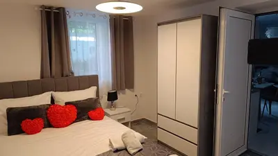 a bedroom with two red pillows on a bed at Villa Eunomia in Gennadi