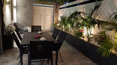 a dining room with a table and some plants at Villa Eunomia in Gennadi