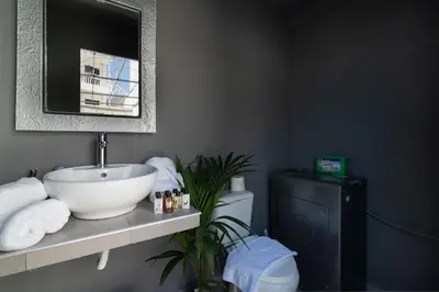 a bathroom with a sink and a toilet at Villa Eunomia in Gennadi