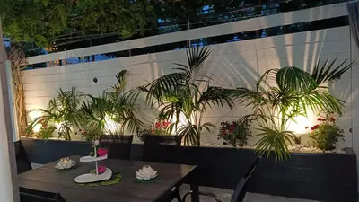 a patio with a table and plants on a wall at Villa Eunomia in Gennadi
