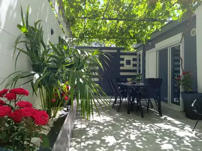 a patio with a table and chairs and flowers at Villa Eunomia in Gennadi