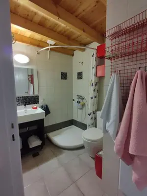 a bathroom with a tub and a toilet and a sink at Omorfo House in Asklipiḯon
