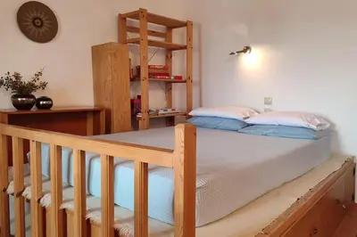a bedroom with a bed and a book shelf at Omorfo House in Asklipiḯon