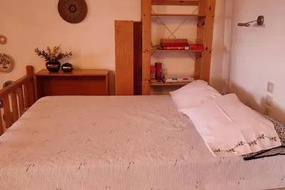 a bedroom with a bed and a book shelf at Omorfo House in Asklipiḯon