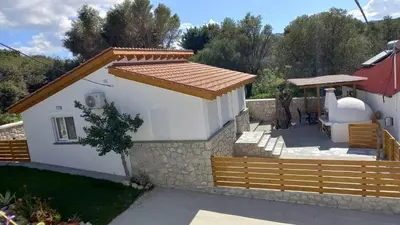 a small white house with a wooden fence at CASA DI'ELEN in Faliraki