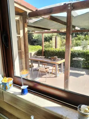 a view of a patio through a window at Green Heaven in Koskinou