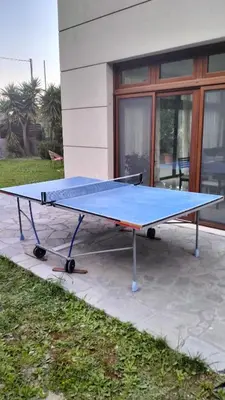a ping pong table in front of a building at Green Heaven in Koskinou