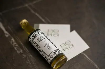 a bottle of wine sitting on top of a table at Nόka Suite Apartments in Faliraki