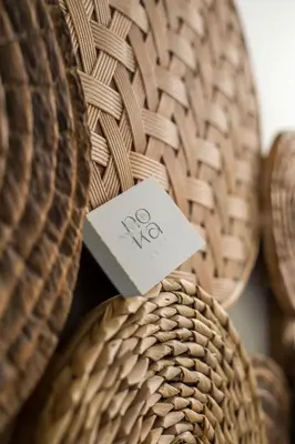 a piece of paper sitting on top of a wicker chair at Nόka Suite Apartments in Faliraki