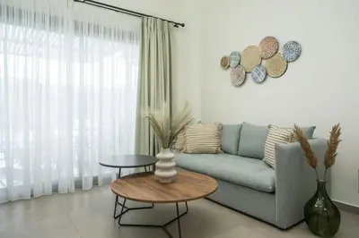 a living room with a couch and a table at Nόka Suite Apartments in Faliraki