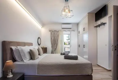 a bedroom with a large bed and a window at San Francisco maisonette in Rhodes Town