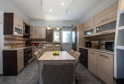 a kitchen with a table and chairs in a room at San Francisco maisonette in Rhodes Town
