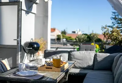 a coffee table on a patio with a couch at San Francisco maisonette in Rhodes Town