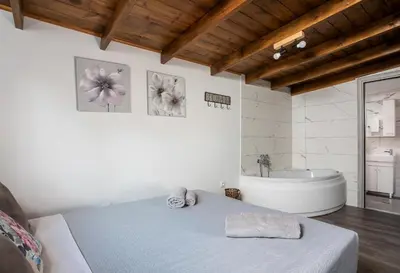a bedroom with a bed and a bath tub at San Francisco maisonette in Rhodes Town