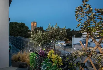 a view of a building with a clock tower in the background at San Francisco maisonette in Rhodes Town
