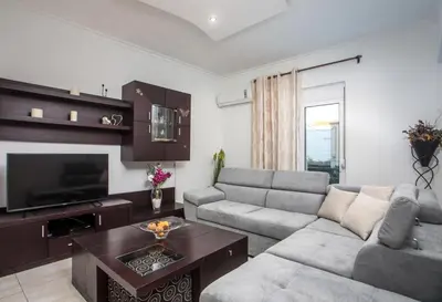 a living room with a couch and a tv at San Francisco maisonette in Rhodes Town