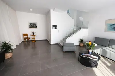 a living room with a couch and a staircase at Euphoria Blue Villa στην περιοχή Ιξιά in Rhodes Town