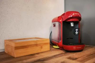 a red and black appliance sitting on top of a wooden counter at Seascape House in Kremasti