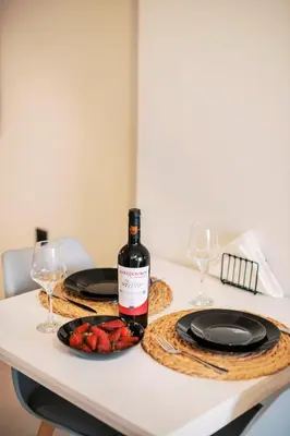 a bottle of wine and a plate of fruit on a table at Seascape House in Kremasti