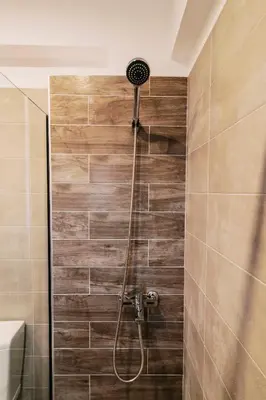 a bathroom with a shower with a shower head at Seascape House in Kremasti